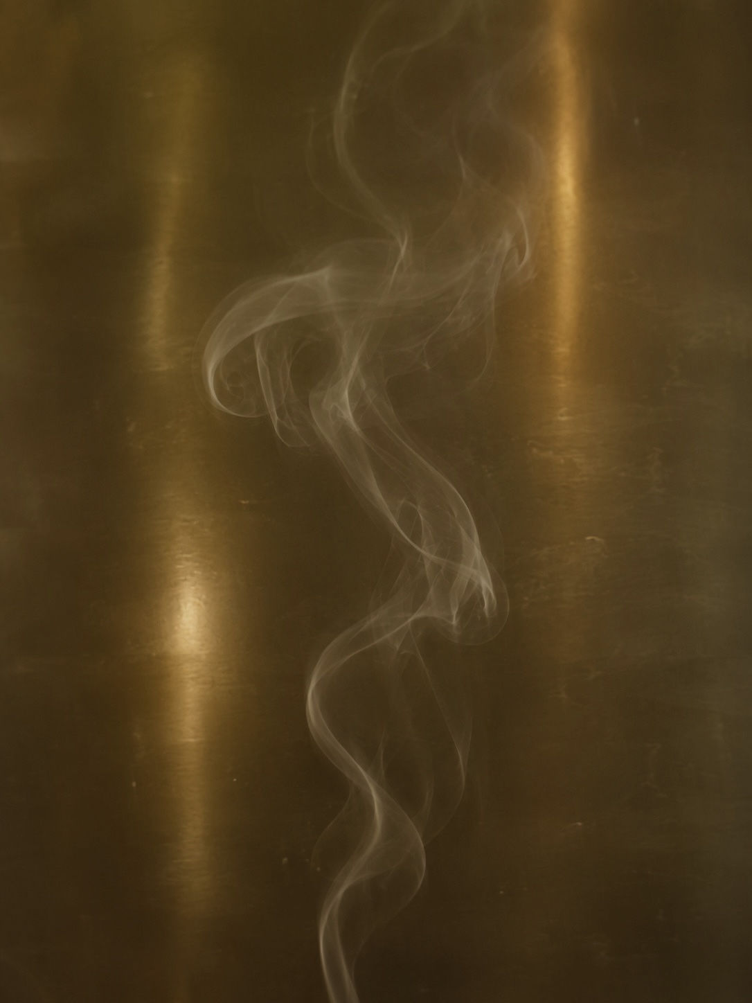 A NIDA JOURNEY candle carried in warm afternoon light